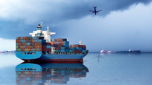 The image depicts a ship with cargo containers